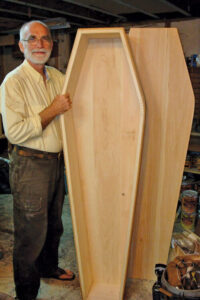 photo of chuck lakin and wooden coffin