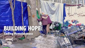 picture of homeless person at encampment with the text building hope ending homelessness
