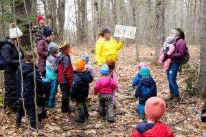 sam cote reading to a group of families in lowell preserve