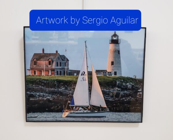 Photograph of a house and lighthouse on rocky coast with a sailboat in the ocean. Also has caption with artist's name.