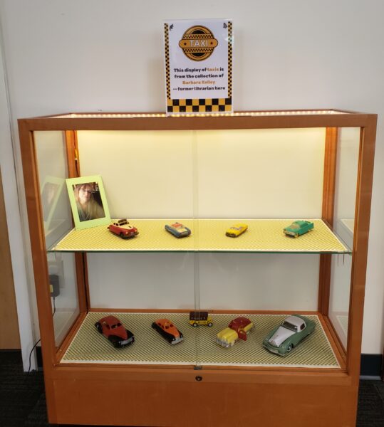 image of display case holding toy taxi car collection